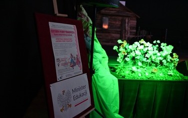 Plakat przedstawiający datę spektaklu, miejsce oraz dofinansowanie oraz scenę wraz z dekoracjami. 